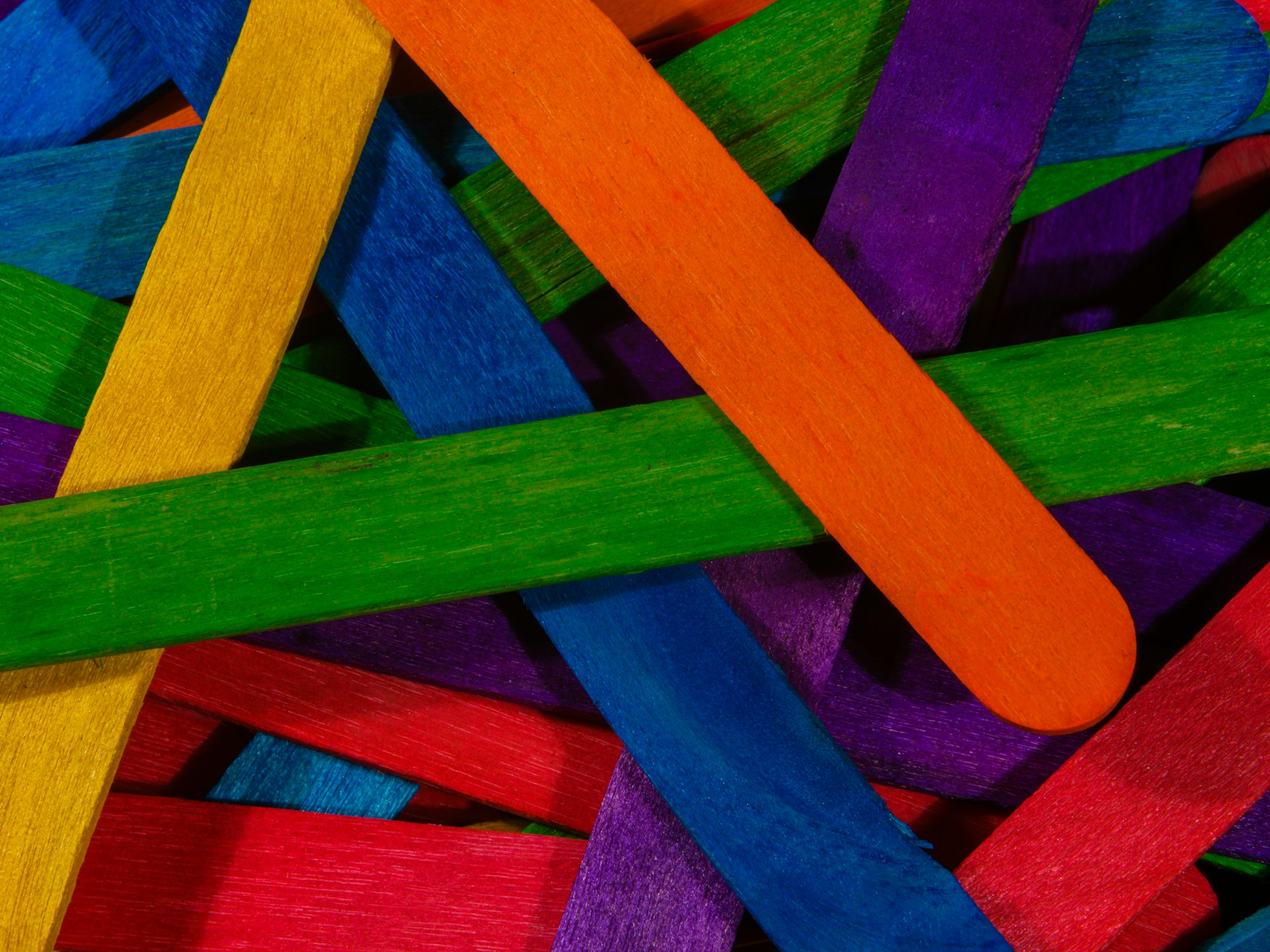 a close up of a pile of colored sticks